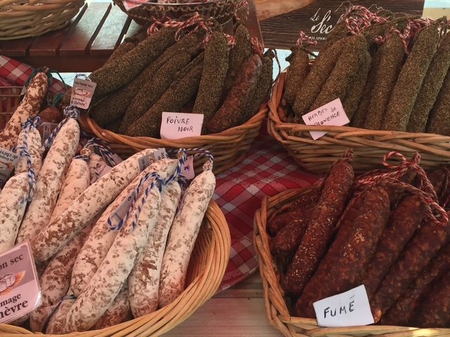 Baskets of saucissons with handwritten labels